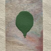 Green Lacquered Balloon floating in Smokey Desert Skies Cover