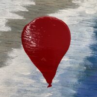 Red Big Balloon floating Slowly Towards the Sky Cover