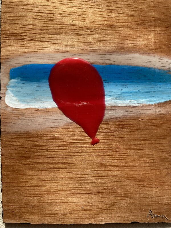 Red Balloon along Sand Puddled Skies